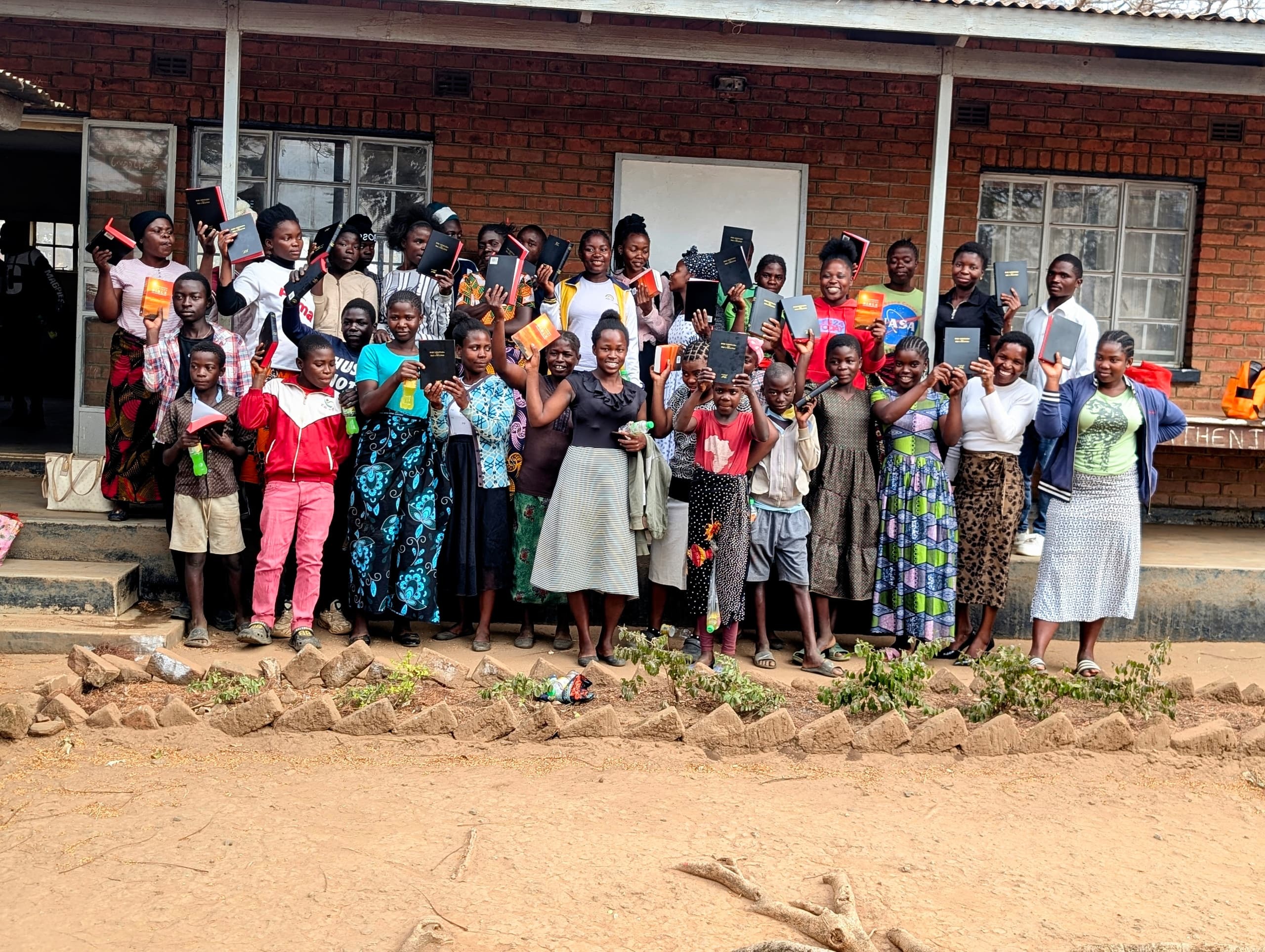 Youth and children receiving Bibles in Malawi